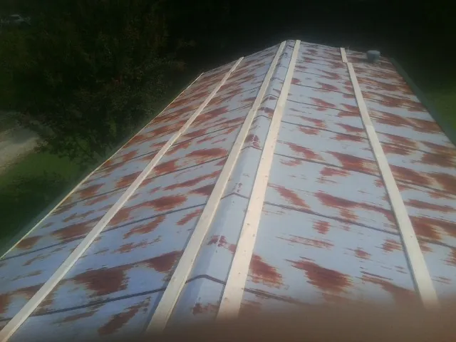 Rusted metal roof panels with new wood purlins before replacement — Storm Damage Roof Repair in Stockton by Roofing Brothers